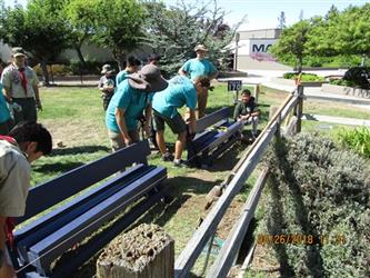 People installing benches with troop 170.