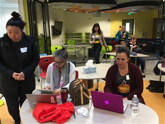 Two teachers working on laptops