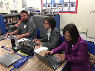 People doing work on laptops