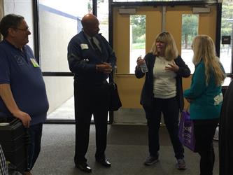 People speaking with each other in front of a door