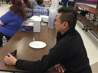 A man with a smartphone at a table