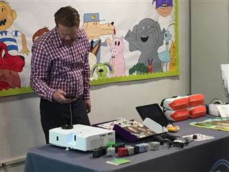 A teacher configuring a projector
